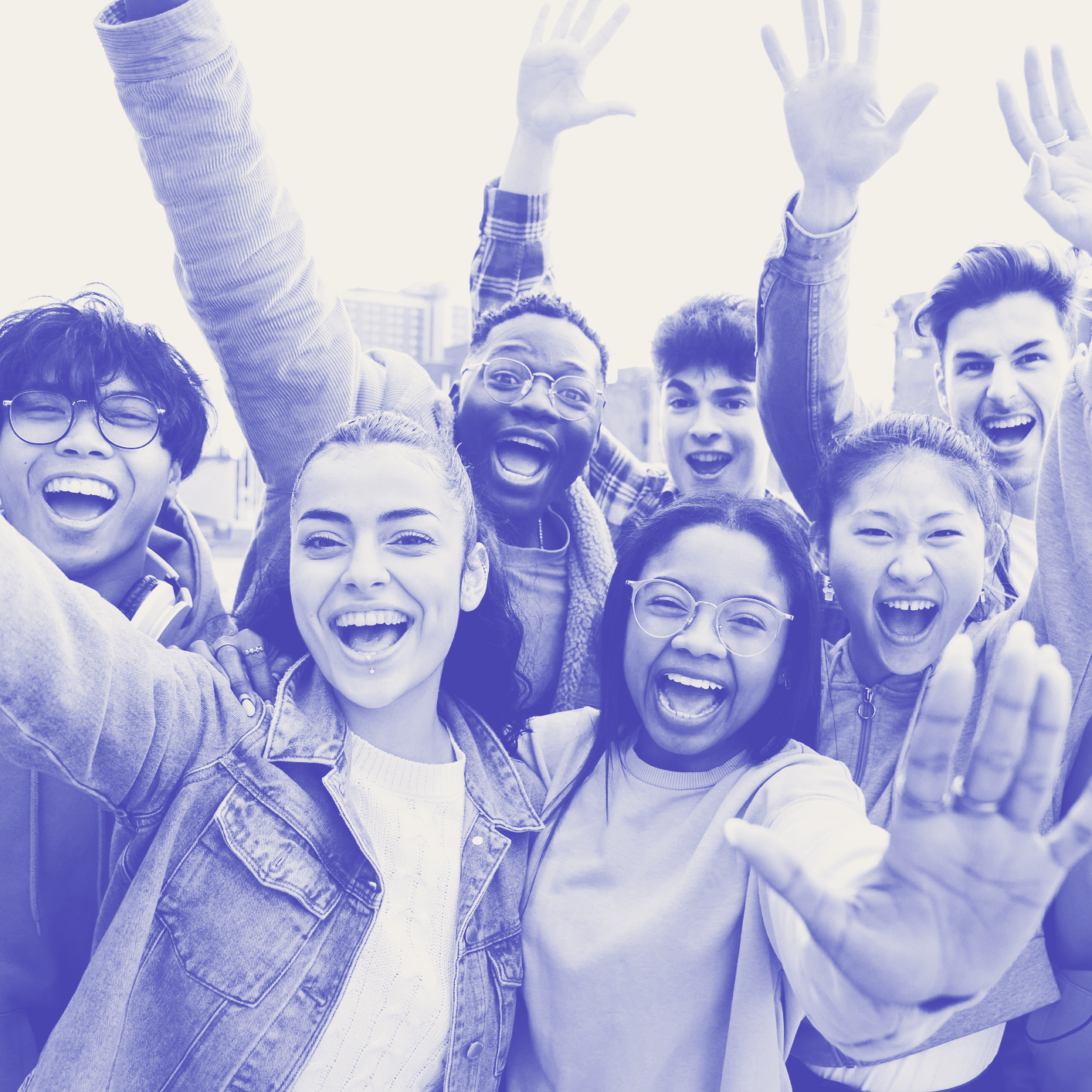 A photo of students raising their hands with excitement